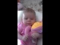 baby tries to hold seahorse toy