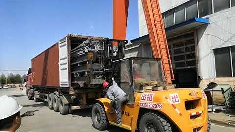 loading steel structure into shipping container with tray