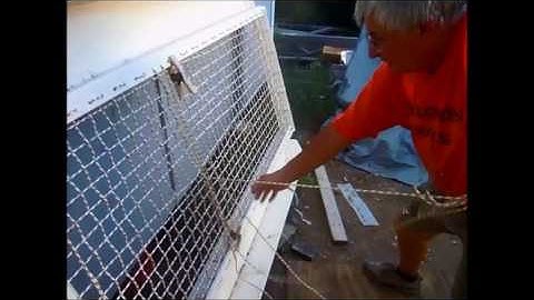 A cat named Dog. Weaving the net of the boarding ramp for a Wharram Tiki 38 Sailboat.