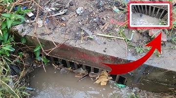 Removal Plastic and Trash Clogged Culvert Drain After Heavy Rain
