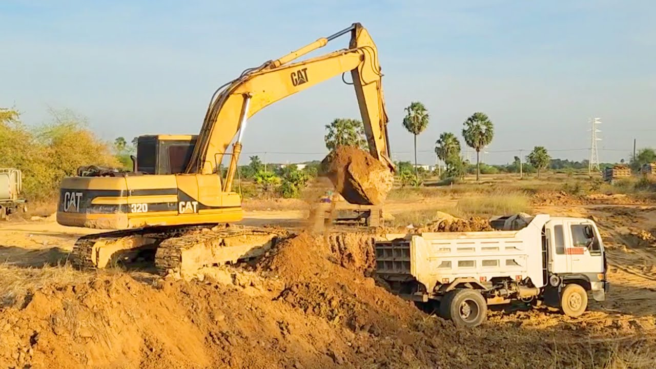 Action excavator cutting land input on truck