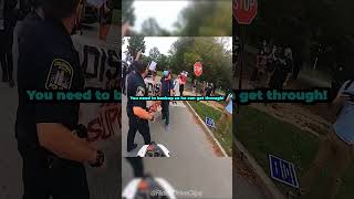 Protesters try to stop biker in the middle of the road😱