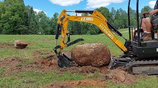 2 ton excavator digs out 3,000lb rock!!!