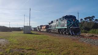 Northbound Repainted FEC 813 passing NSB Yard. 2/28/24