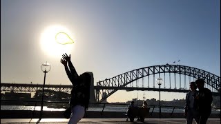 Yelllow Balloon Blowing And Popping A Balloon At The Sydney Opera House