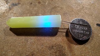 Flickering blue LED cast into glowing resin obelisk.