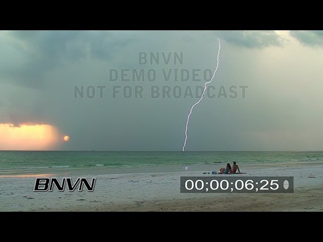 8/28/2007 Lightning Bolts strike as people watch on the storm on a beach