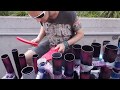 London street artist Joe Hammond pipe drumming on plastic tubes with slippers