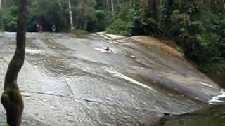 Sliding head first down a rock