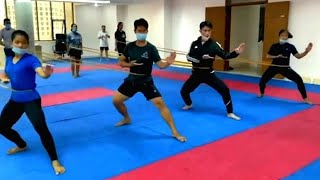 Karate exercises legs and hands speed and strength with rubber.