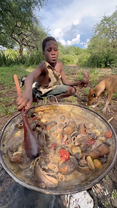 A moment of skill and patience, as a Hadzabe boy prepares his meal in the wild.