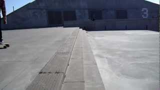 Oscar jumping down stairs on Longboard.