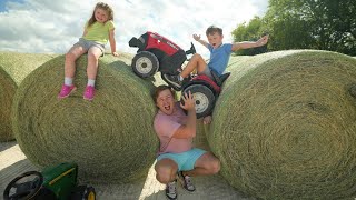 Hudson vs Holly racing tractors and playing on hay | Gross Jellybeans | Tractors for kids
