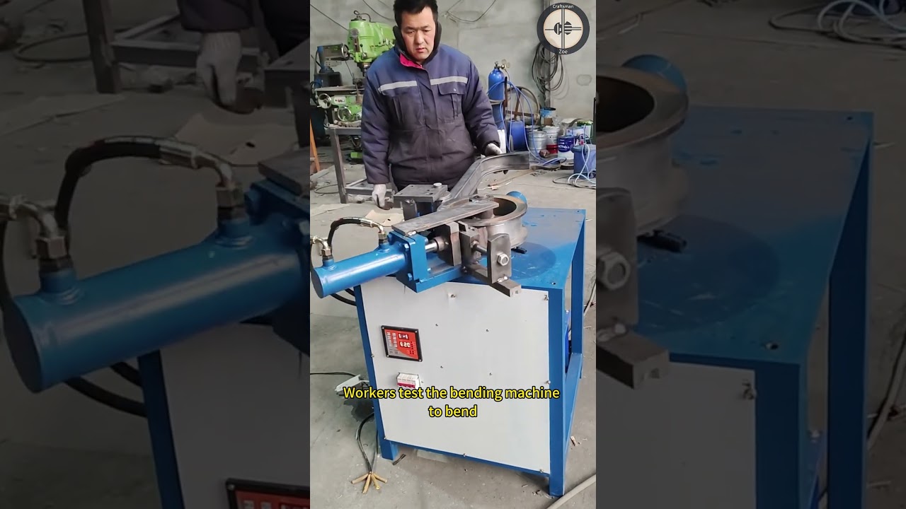 Workers test the bending machine to bend square seamless stainless steel pipes