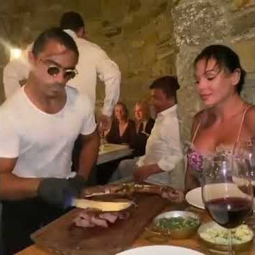 Salt Bae is serving steak very nicely to Lady