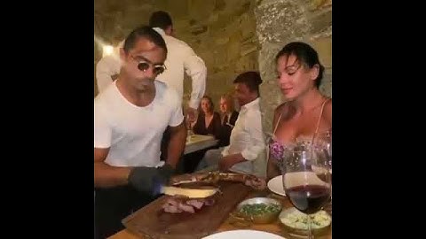 Salt Bae is serving steak very nicely to Lady