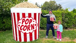 A Giant Bucket Of Popcorn With Crispy Chicken Strips And Potato Fries!