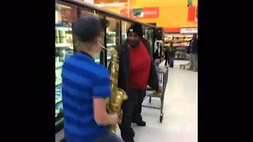 KID PLAYING SAXOPHONE FOLLOWING FAT DUDE IN SUPERMARKET (revisited)