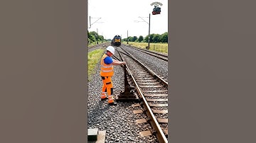 Worker Operates Switch as Train Changes Track