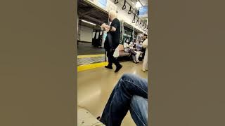 Japanese man tries to drag foreigner off the train for being loud and drinking.