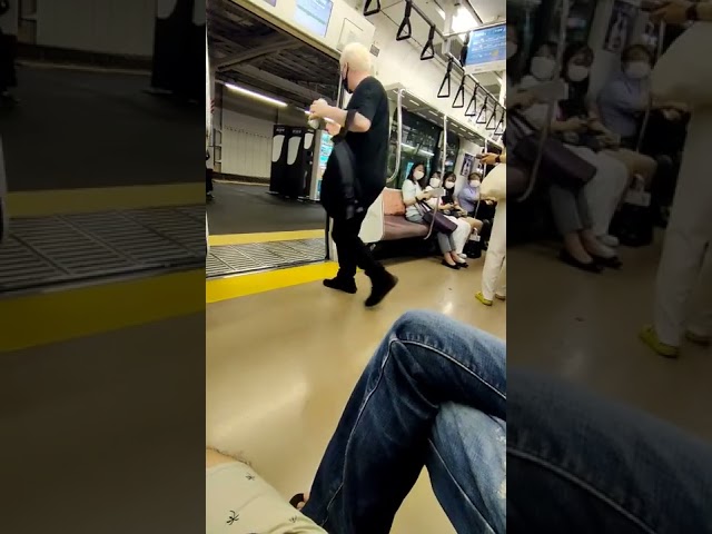 Japanese man tries to drag foreigner off the train for being loud and drinking. class=