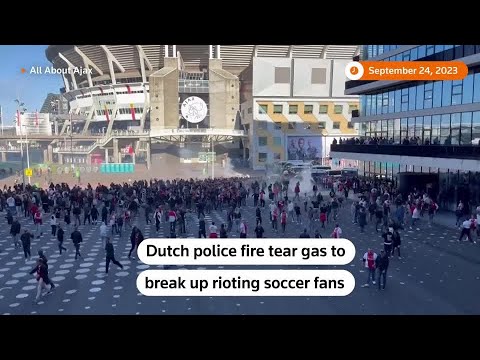 Police use tear gas to disperse rioting Ajax fans