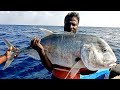 Catching giant trevally fish in the deep sea