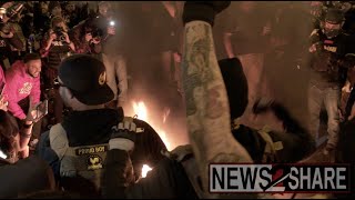 Proud Boys face off with police and counter protesters in DC, burn church's banner