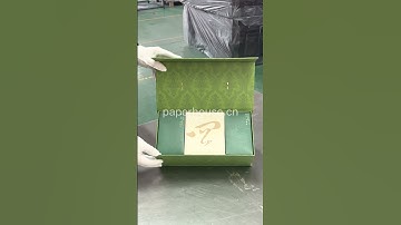 green clamshell box with golden metal handle