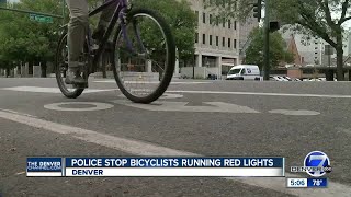 Police stop bicyclists running red lights in Denver