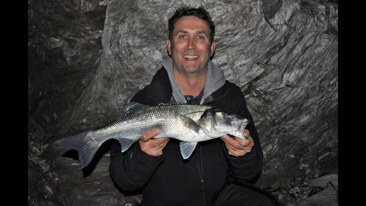 UK Bass fishing with senkos at night. A client's 5lb bass being safely