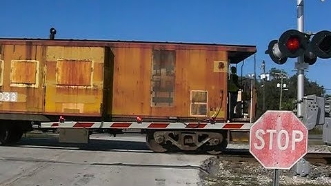 CSX Freight Train In  Reverse With The Caboose  Rolling Through  Plant City,Florida.