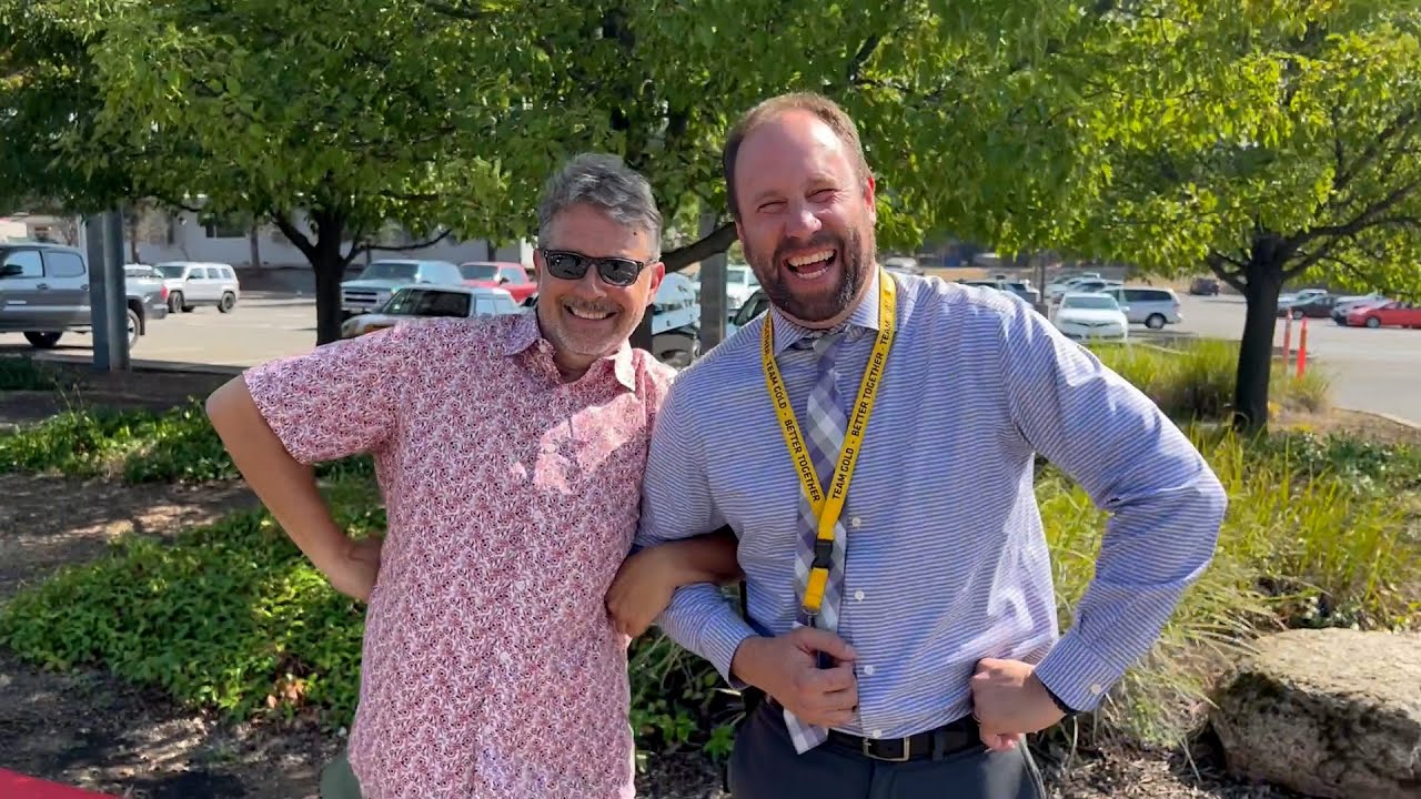 Video preview image of Two guys laughing and locking arms in the Del Oro parking lot.; click to visit the ParentSquare post with the video