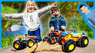 Toy Monster Trucks for Kids Feed Ducks at a Pond