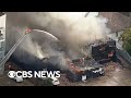 Nearly 100 firefighters battling major apartment fire, possible explosion in Dallas