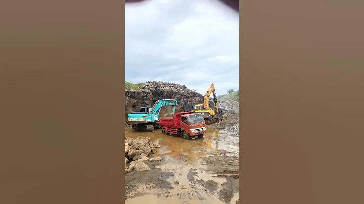Excavator with dump truck digs rocky soil on road construction #excavator #heavymachinery