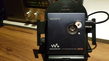 How  does a download button on a Net MD player work?