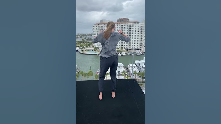 High diver sits on the edge of the 27m platform in super windy conditions!