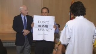 Tough crowd heckles McCain in town hall meeting on Syria