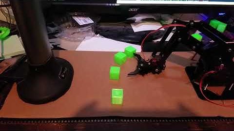 Autonomous robot arm picking up blocks