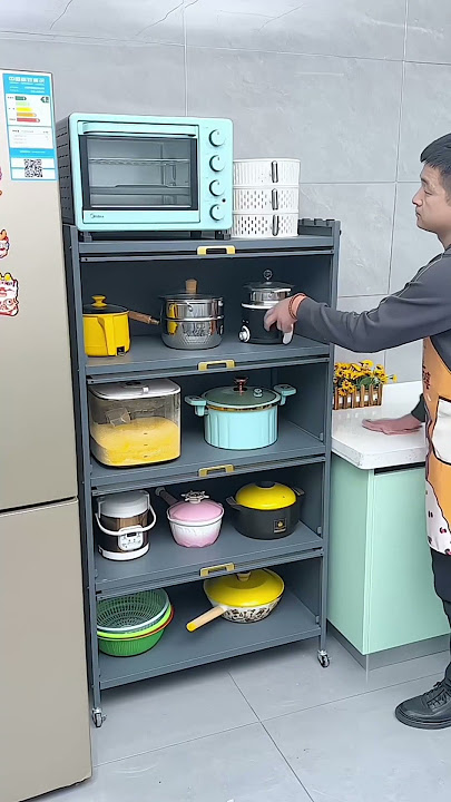 Kitchen rack with cabinet doors, floor-standing multi-layer storage cabinet, microwave oven, pots.