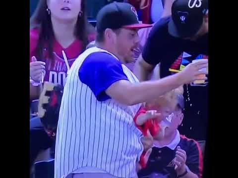 Dad lets go of baby to catch a baseball and catches baby before she falls while saving his beer.