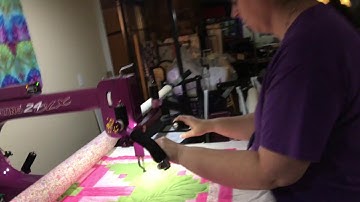 Ann Long arm quilting some feathers.