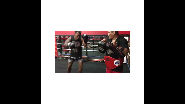 Marcelo Lumakang holding pads for Muaythai Fighter...