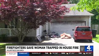 Firefighters save woman trapped in house fire