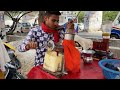 This young manking orange juice with hands - indian Street Food