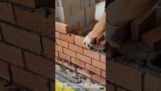 The process of laying red bricks on a single brick for indoor partition walls