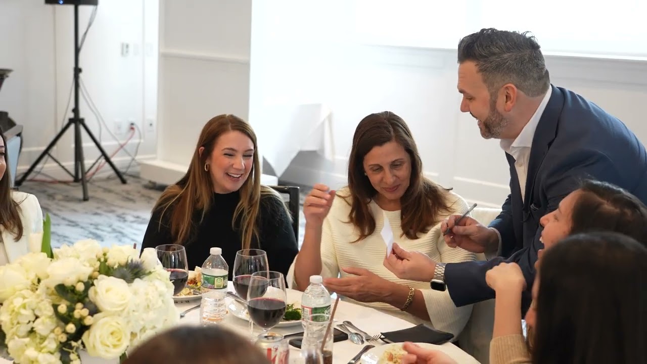 Corporate magician for events Tom Kennedy performing as guests react with surprise and laughter at a company event
