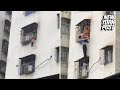 Toddler dangles by his head out of a window