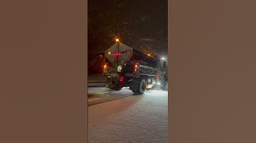 Modern Snow Plow Driving Through Heavy Winter Storm